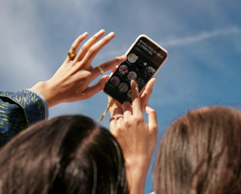 phone in hand with spotify app opened